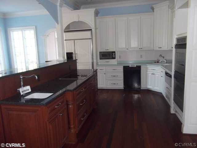 1661 Huntingdon Road Crozier, VA 23039 - Photo 4 of 5 a kitchen with granite countertop a sink dishwasher stove and cabinets