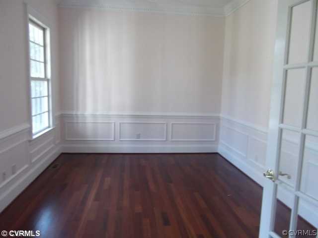 1661 Huntingdon Road Crozier, VA 23039 - Photo 5 of 5 an empty room with wooden floor and windows