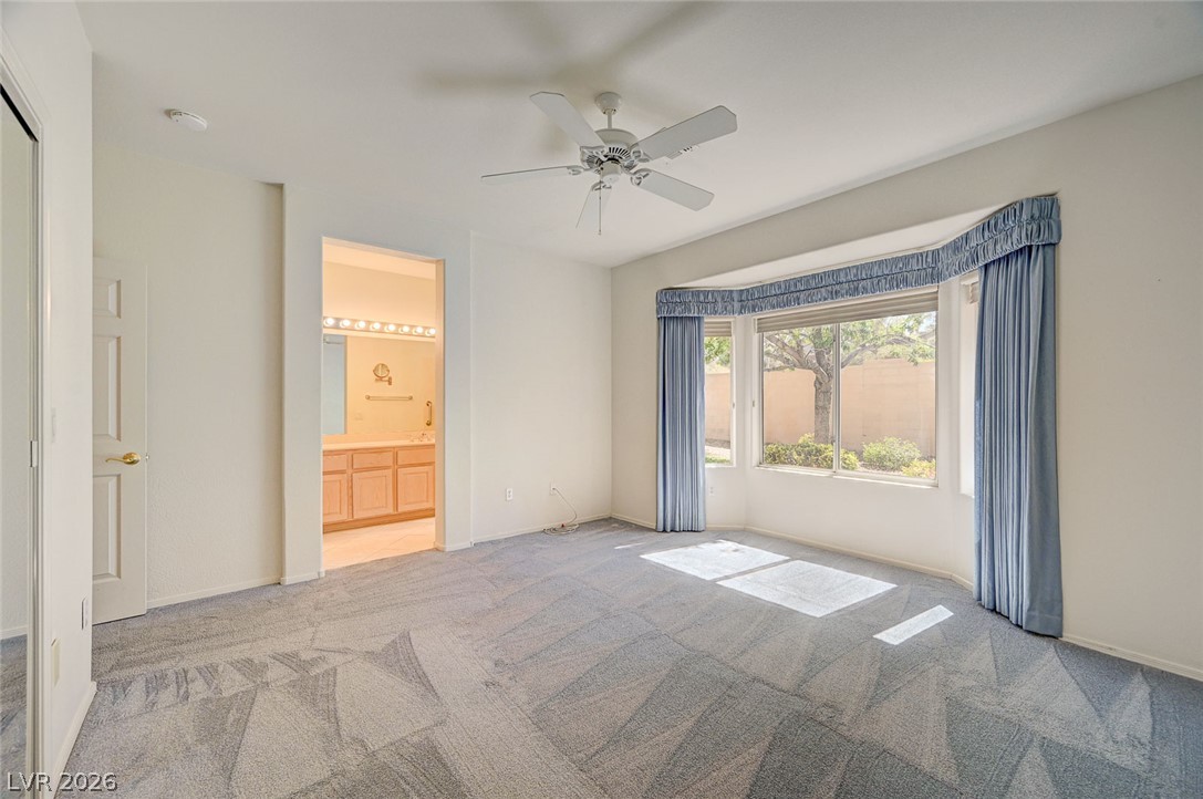 2529 Springville Way Henderson, NV 89052 - Photo 32 of 70 Plentiful natural light streams through a classic bay window onto the patterned carpeting.
