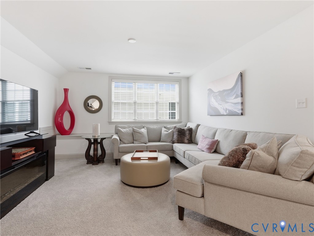 12520 Donahue Road Glen Allen, VA 23059 - Photo 24 of 35 a living room with furniture a flat screen tv and a window