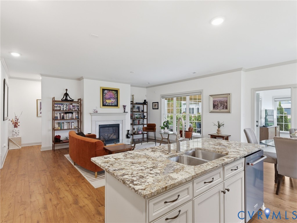 12520 Donahue Road Glen Allen, VA 23059 - Photo 7 of 35 a kitchen with stainless steel appliances granite countertop a sink dishwasher and a fireplace with wooden floor