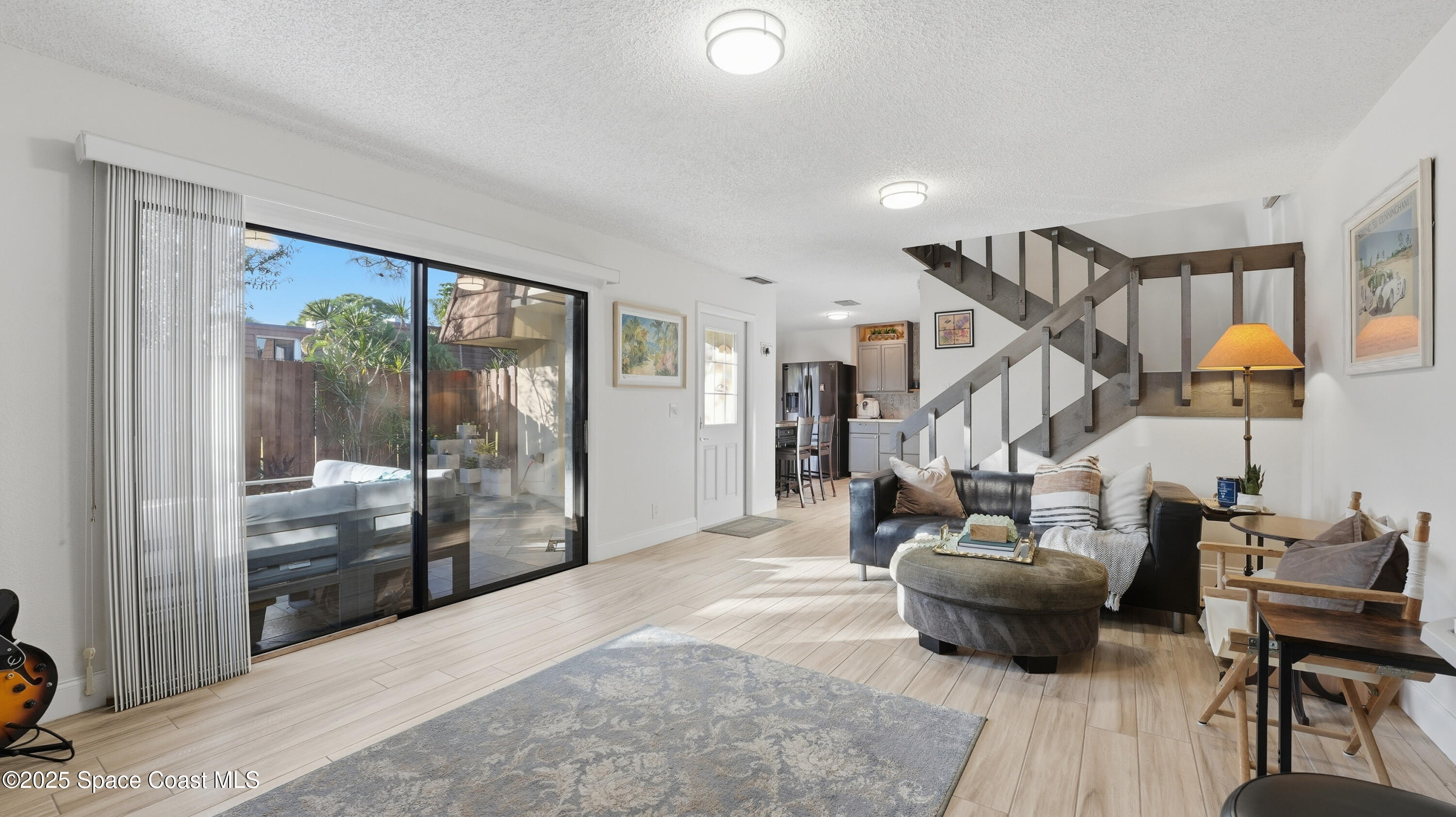 1511 Erin Court Palm Bay, FL 32905 - Photo 15 of 32 a living room with furniture and a floor to ceiling window