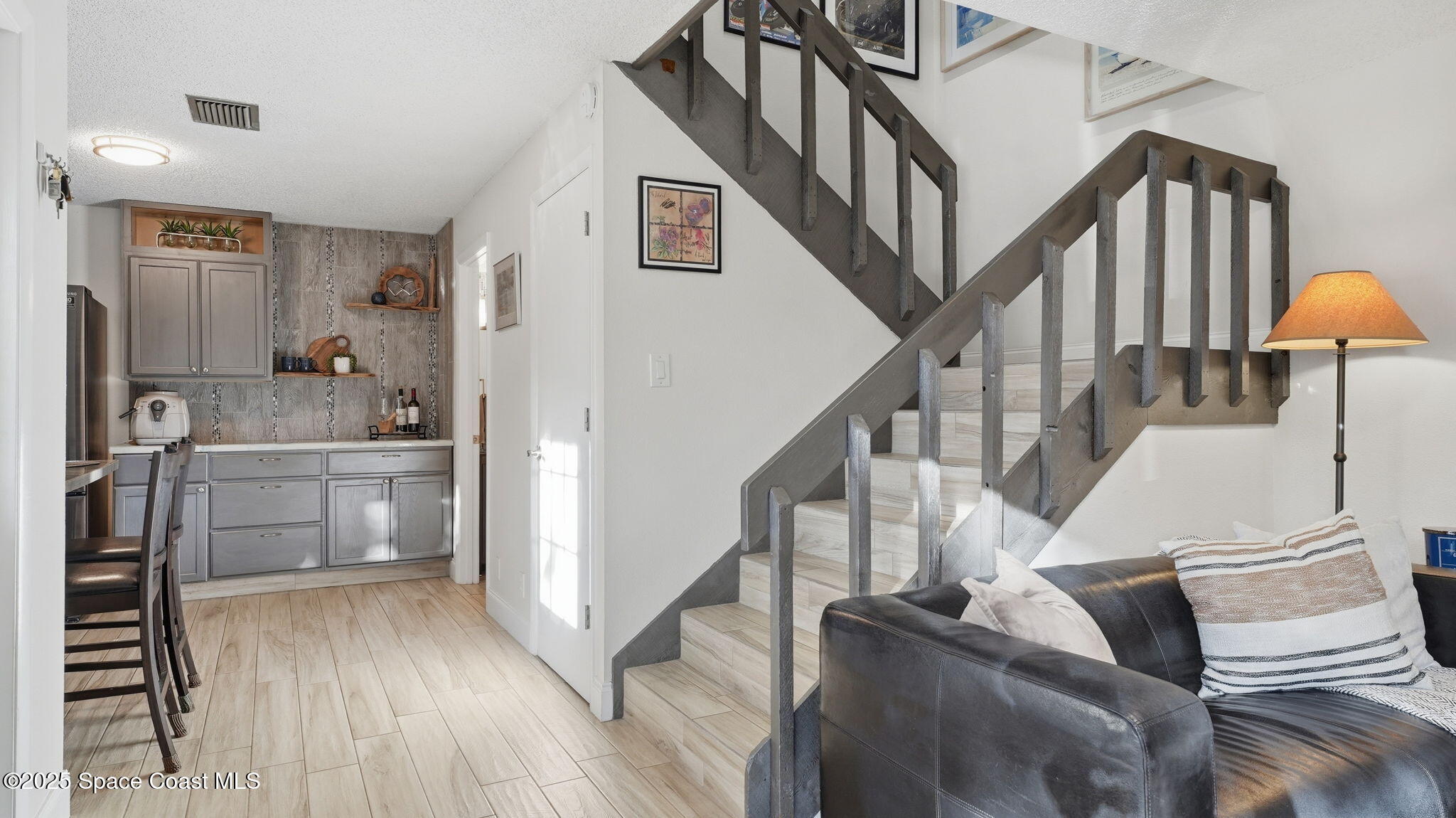 1511 Erin Court Palm Bay, FL 32905 - Photo 17 of 32 a view of entryway and kitchen with wooden floor