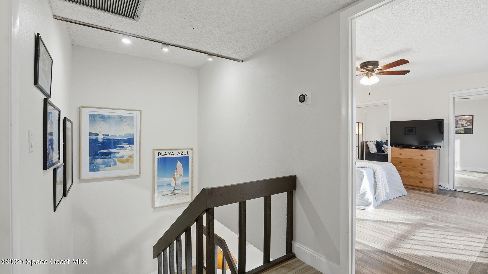 1511 Erin Court Palm Bay, FL 32905 - Photo 18 of 32 a view of a hallway with furniture and a refrigerator