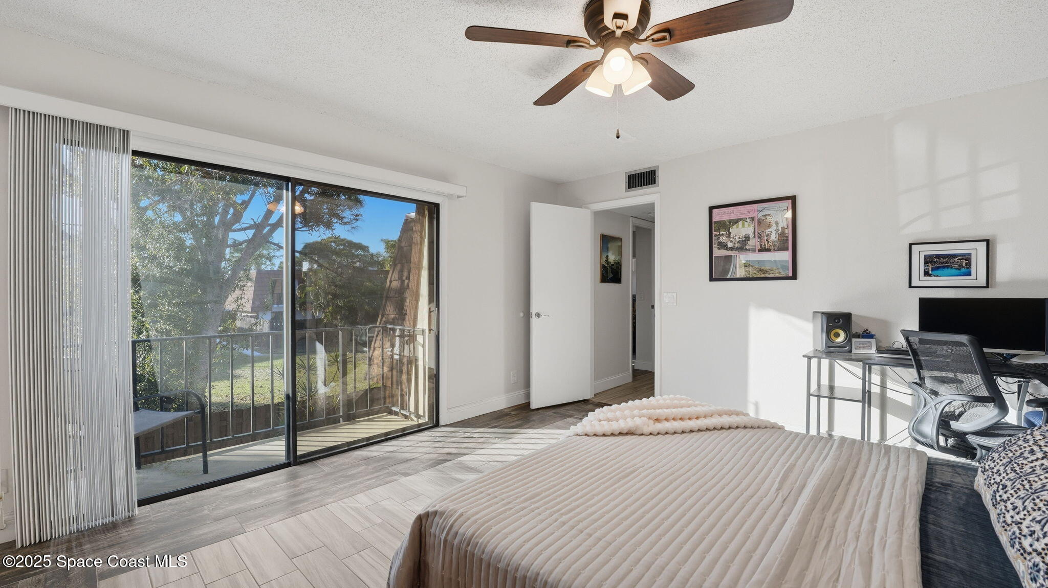 1511 Erin Court Palm Bay, FL 32905 - Photo 20 of 32 a bedroom with a bed and glass window