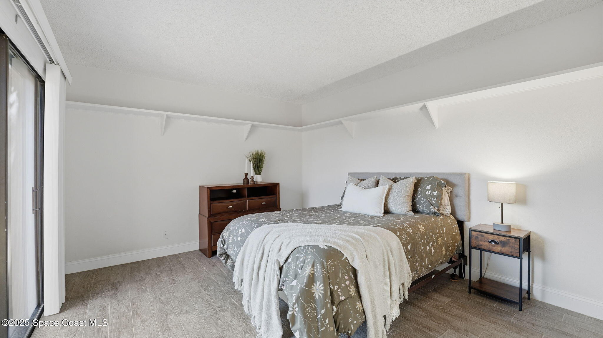 1511 Erin Court Palm Bay, FL 32905 - Photo 21 of 32 a bedroom with a bed and a table