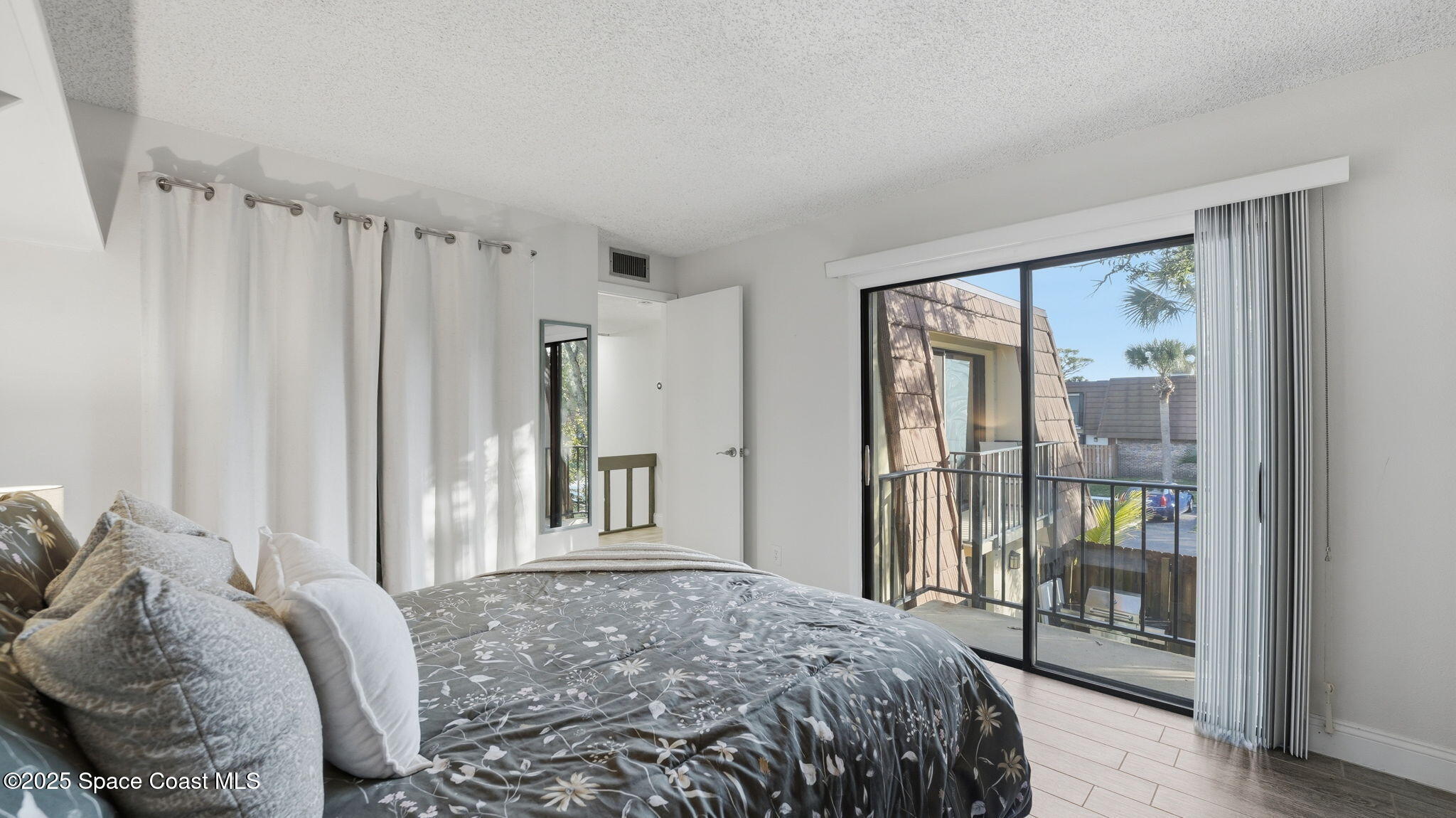 1511 Erin Court Palm Bay, FL 32905 - Photo 22 of 32 a bedroom with a large bed and a window