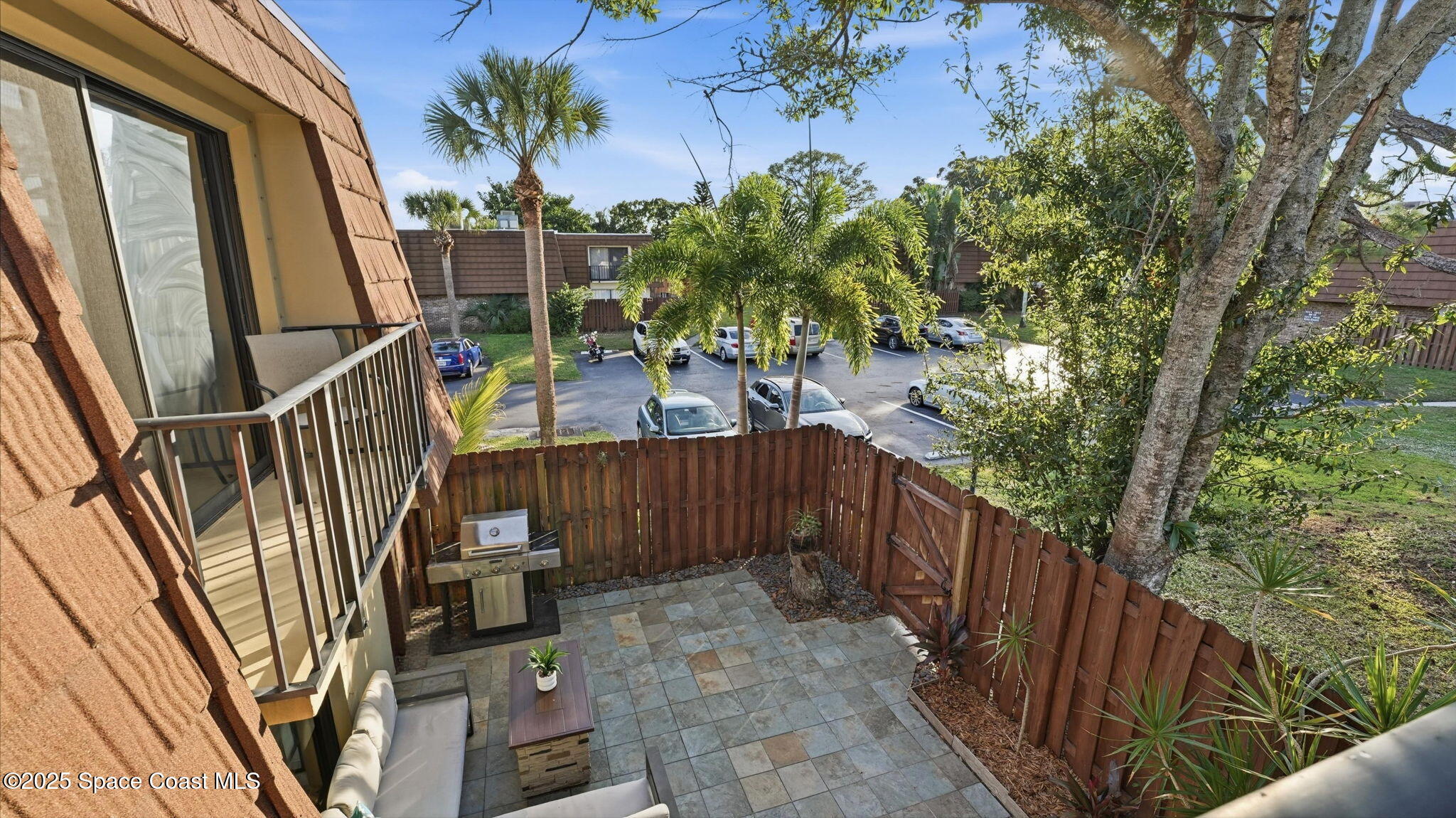 1511 Erin Court Palm Bay, FL 32905 - Photo 27 of 32 a view of balcony with wooden fence and potted plants