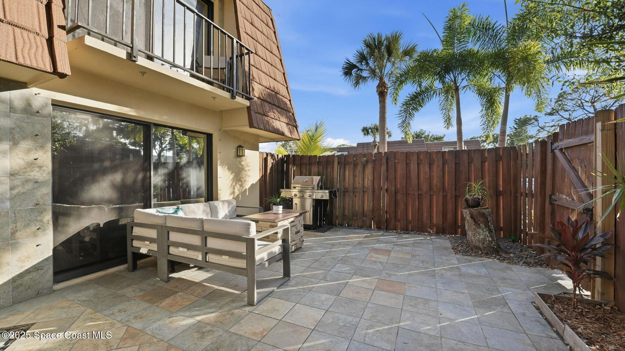 1511 Erin Court Palm Bay, FL 32905 - Photo 5 of 32 a view of a patio with a table and chairs and potted plants