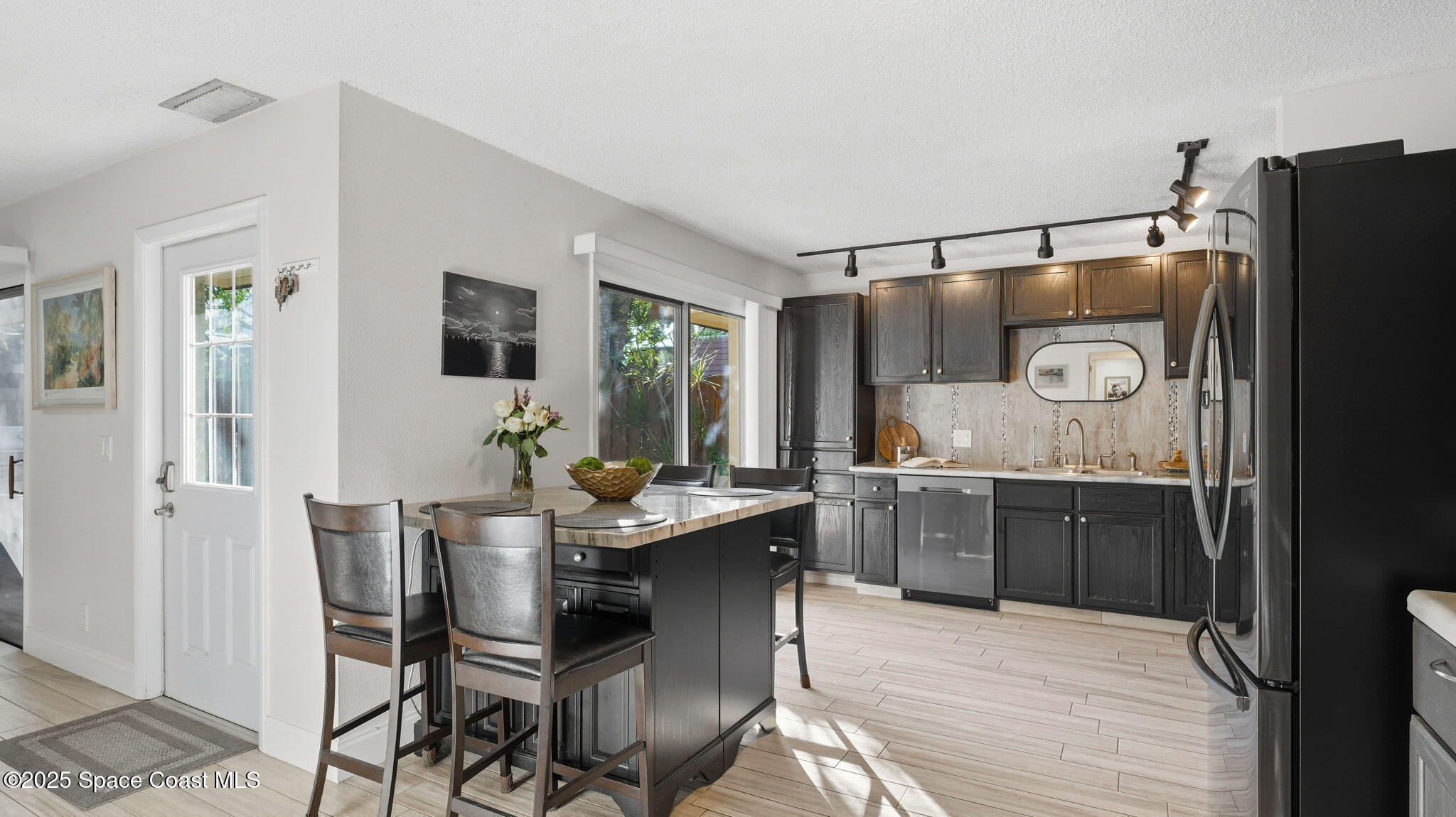1511 Erin Court Palm Bay, FL 32905 - Photo 7 of 32 a dining hall with stainless steel appliances granite countertop a dining table and chairs