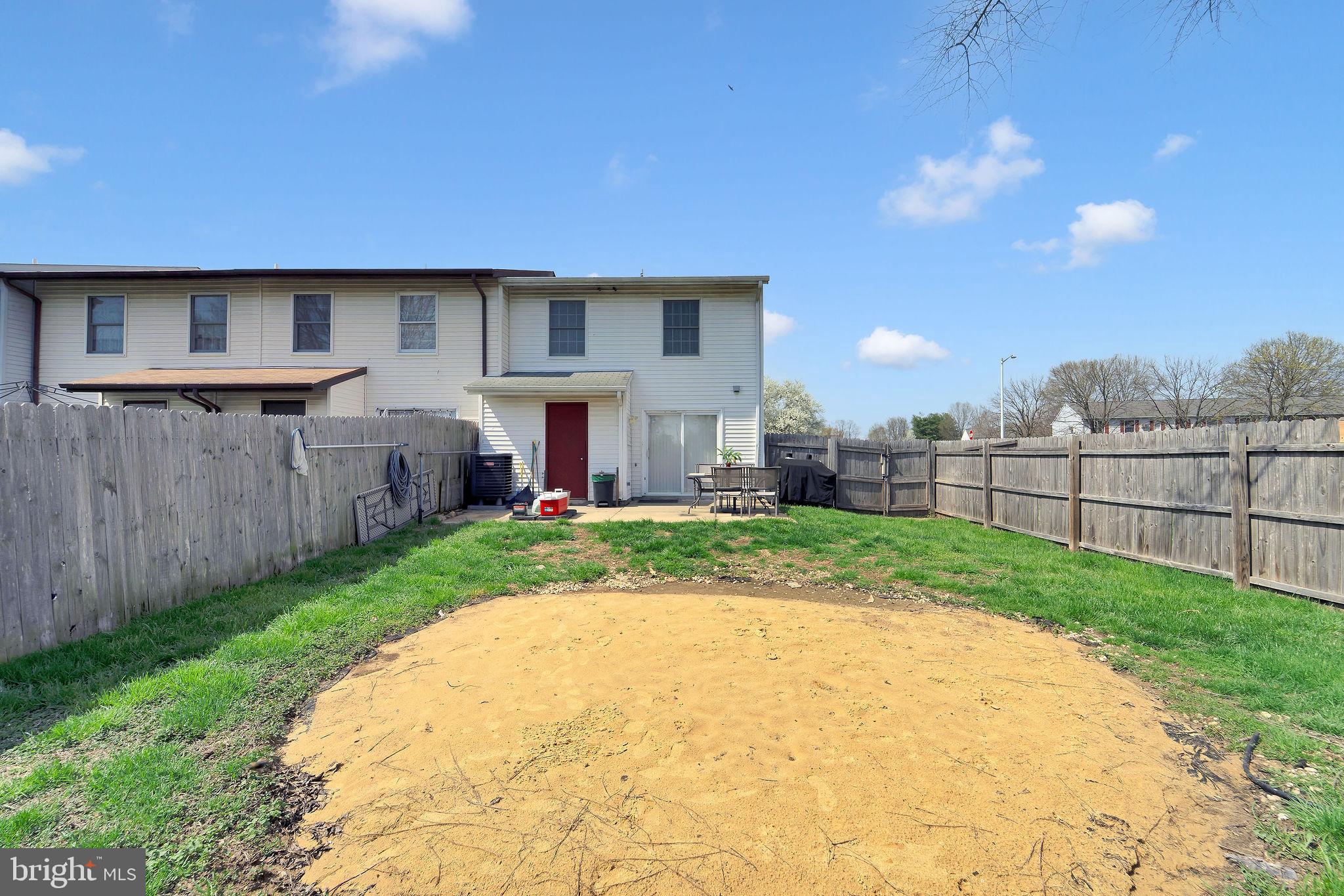 6 Transom Court Elkton, MD 21921 - Photo 27 of 33 a view of a backyard with table and chairs a barbeque and wooden fence