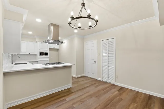 a view of a kitchen counter space and wooden floor