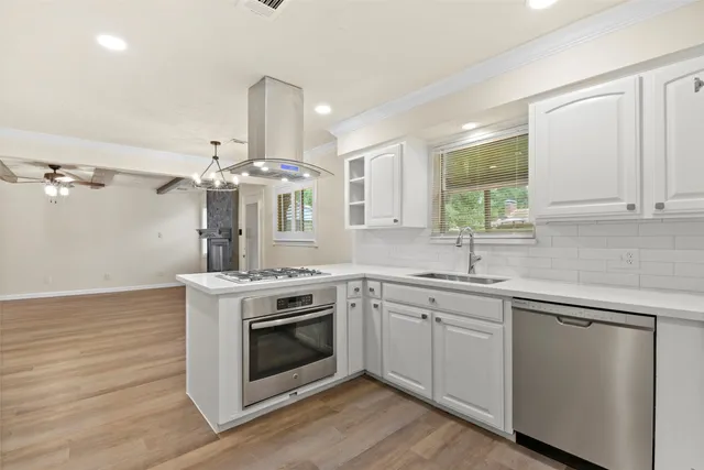 a kitchen with a stove and sink