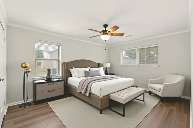 a bedroom with a bed and a chandelier