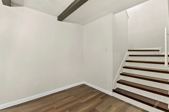 a view of a room with wooden floor