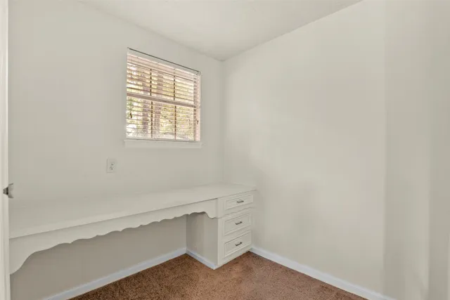 a view of storage and utility room with window
