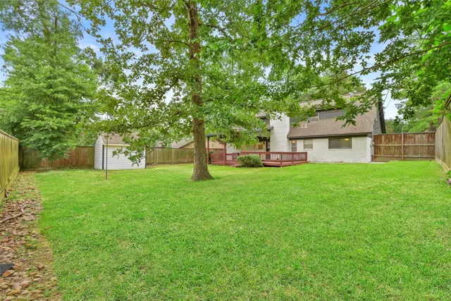 a front view of a house with yard and green space