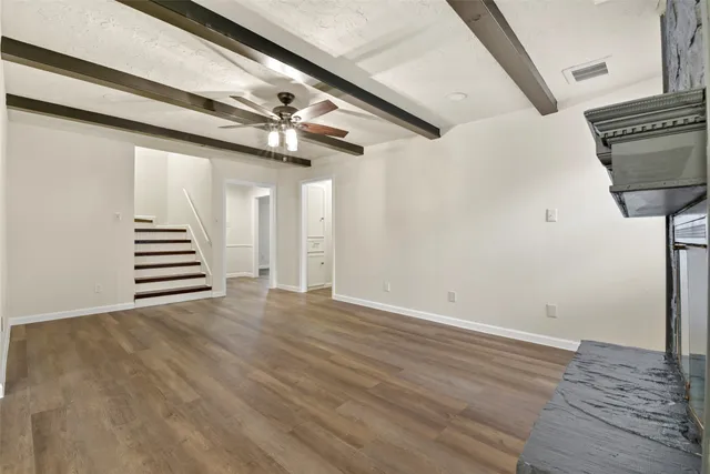 a view of an empty room with stairs and ventilation