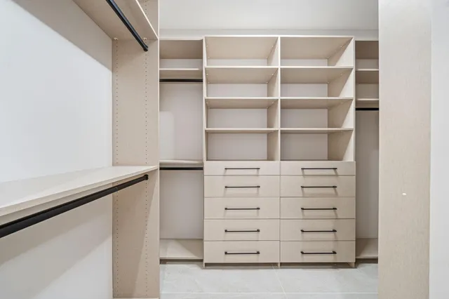 a white bath tub sitting in a bathroom next to a window