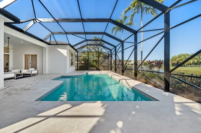 a front view of a house with a garden and trees