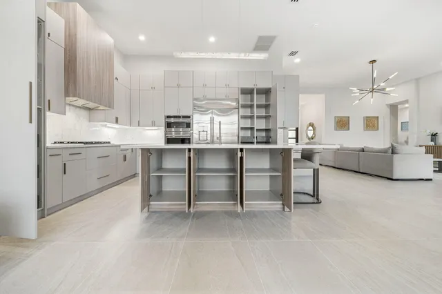 a kitchen with cabinets and chairs