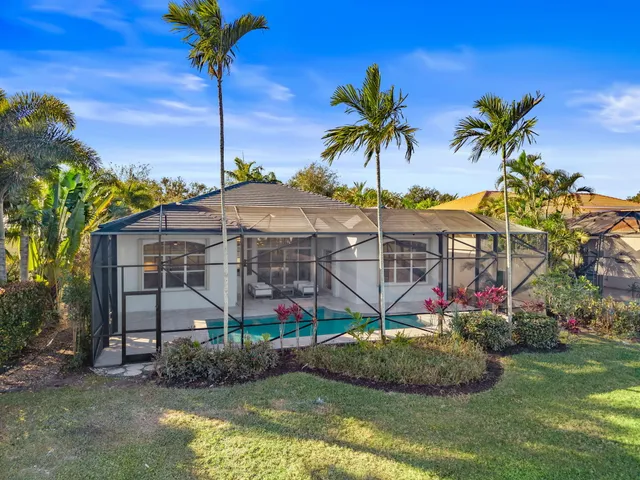a view of a swimming pool with an outdoor seating and a yard
