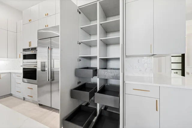 a kitchen with stainless steel appliances a refrigerator and cabinets