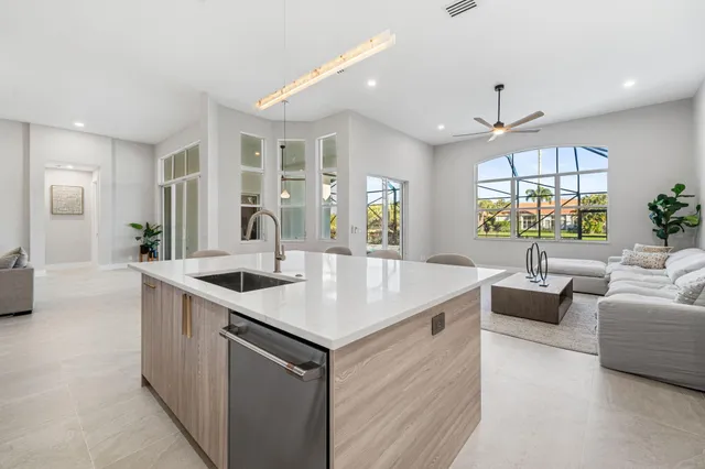 a kitchen with center island a sink dishwasher a stove and a refrigerator with wooden floor