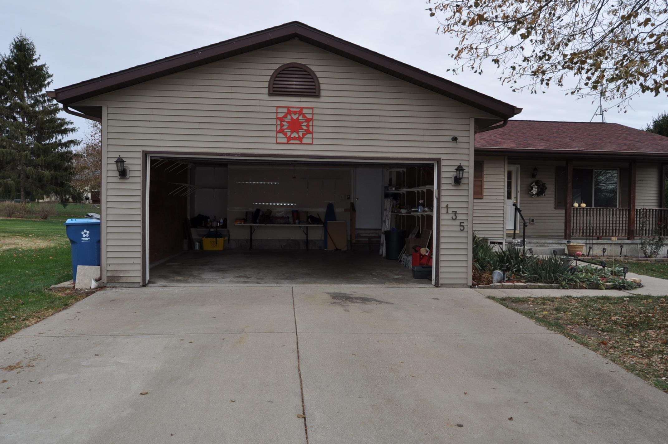 135 Fieldcrest Lane Cedarville, IL 61013 - Photo 33 of 45 a front view of a house with yard and garage
