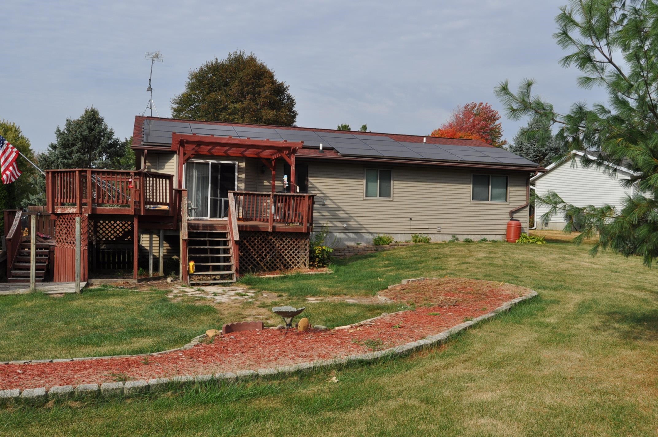 135 Fieldcrest Lane Cedarville, IL 61013 - Photo 43 of 45 a backyard of a house with barbeque oven and seating area