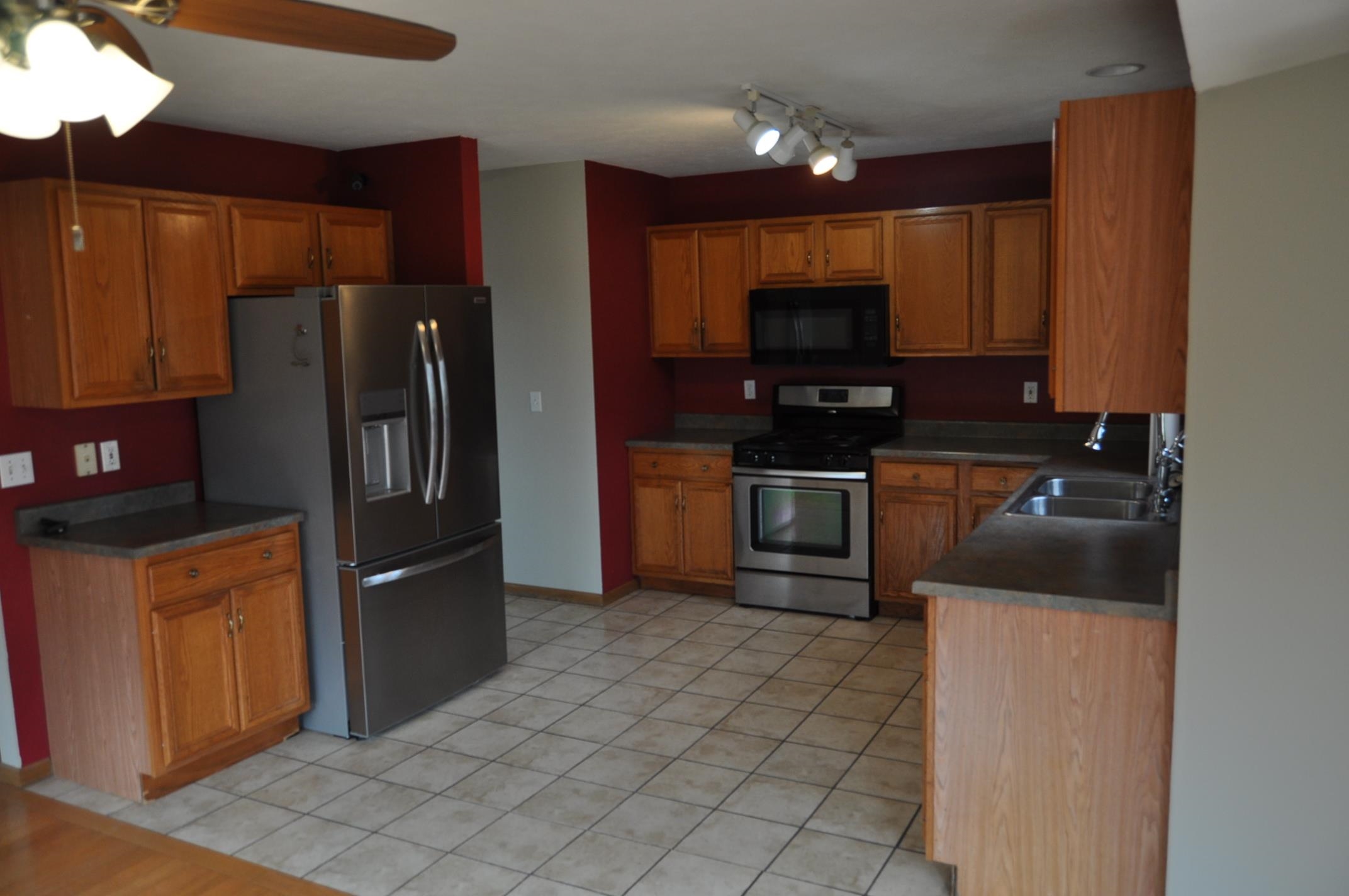 135 Fieldcrest Lane Cedarville, IL 61013 - Photo 5 of 45 a kitchen with stainless steel appliances granite countertop a refrigerator and a stove top oven