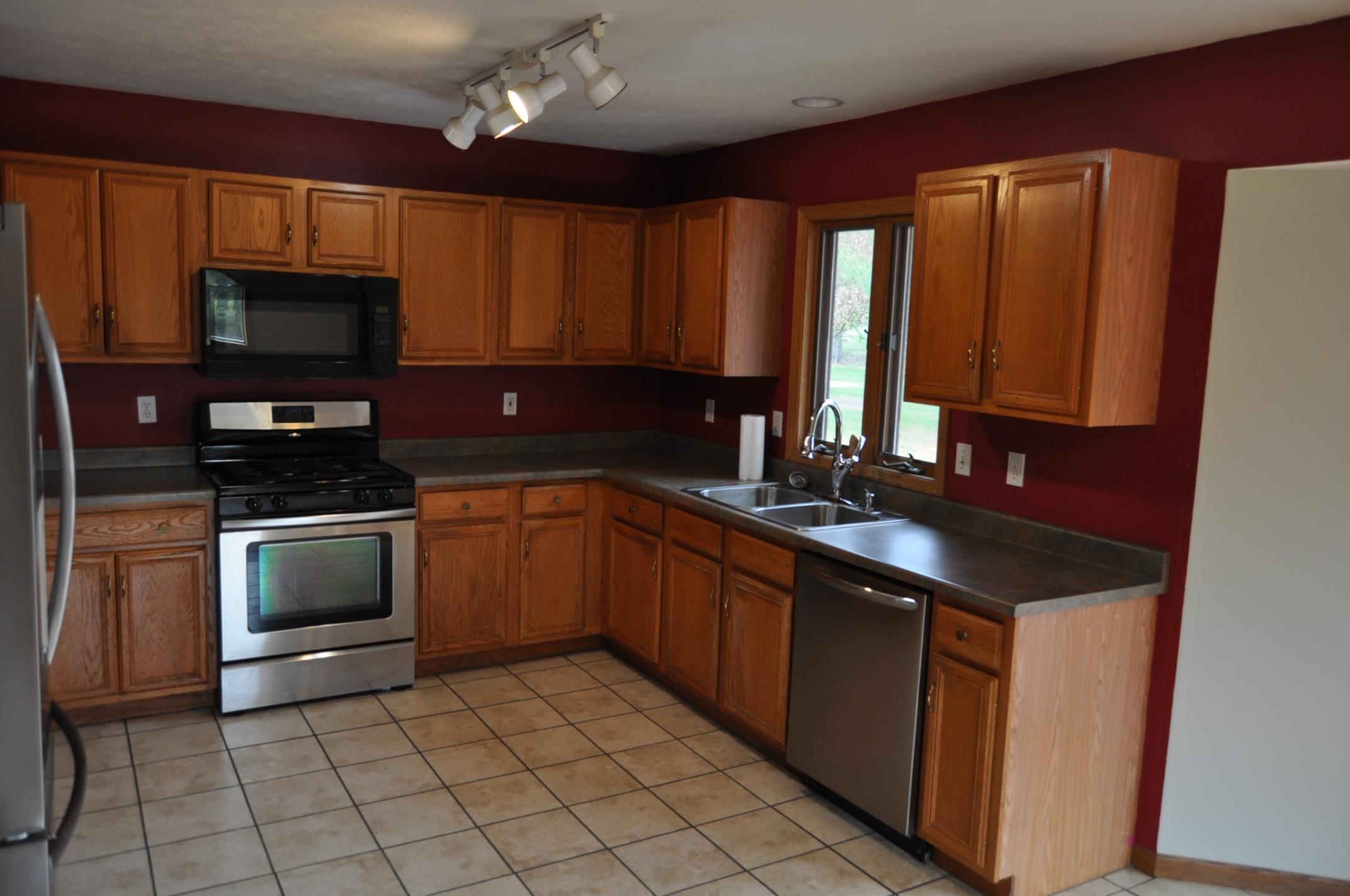 135 Fieldcrest Lane Cedarville, IL 61013 - Photo 6 of 45 a kitchen with a sink stove top oven and cabinets