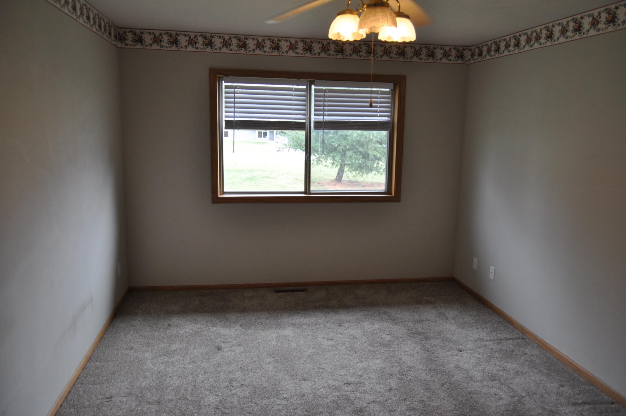 135 Fieldcrest Lane Cedarville, IL 61013 - Photo 8 of 45 an empty room with a window