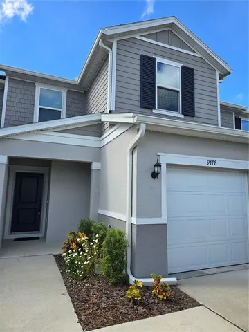 a front view of a house with plants