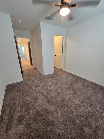 a view of a livingroom with a ceiling fan and window