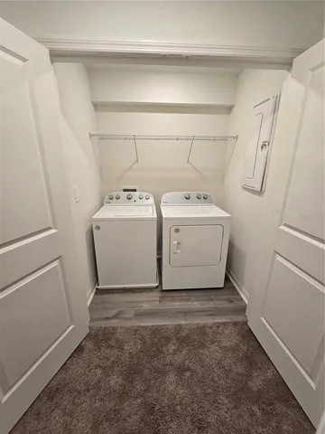 an empty room with a ceiling fan and carpet