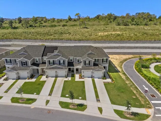 an aerial view of a house with a big yard