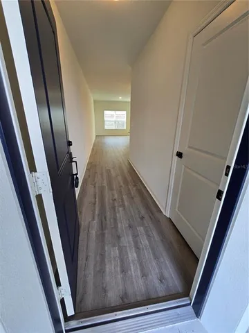 a view of an empty room and wooden floor