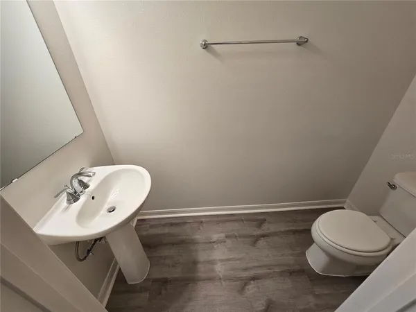 a white toilet sitting next to a bathroom sink