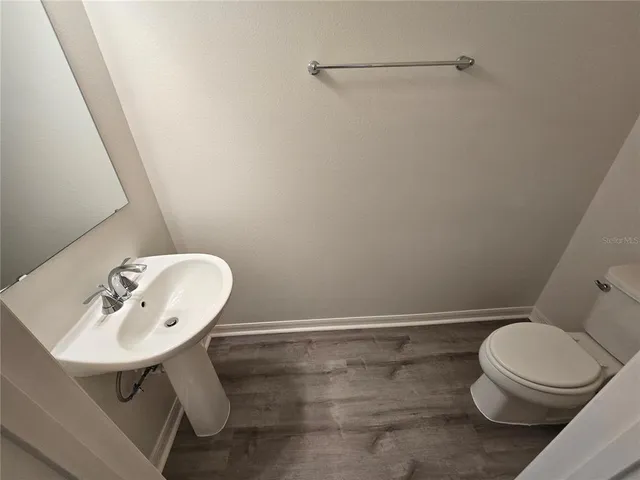 a white toilet sitting next to a bathroom sink