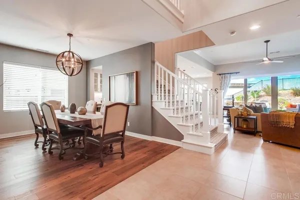 a view of a dining room and livingroom with furniture window and wooden floor
