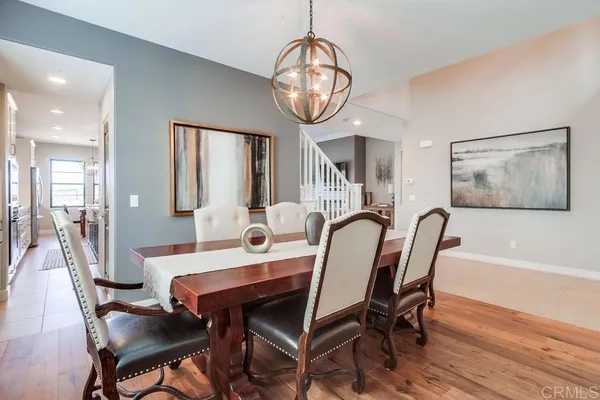 a kitchen with stainless steel appliances granite countertop a sink a stove a refrigerator a kitchen island with chairs and cabinets