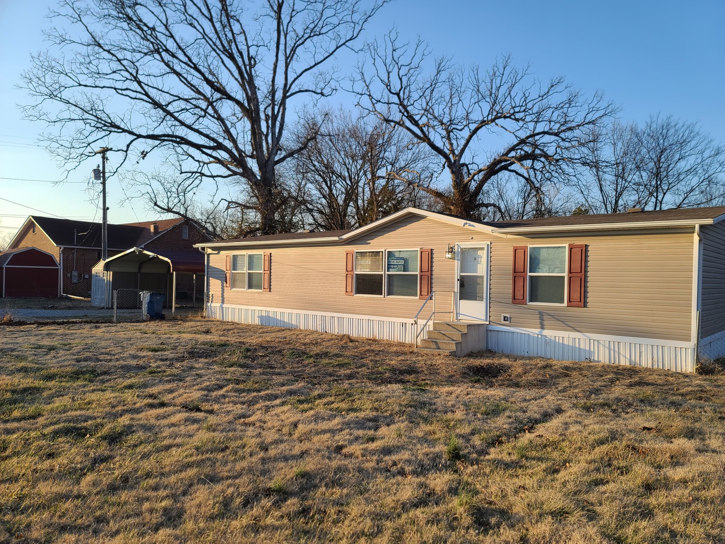 303 Seba Street Hurst, IL 62949 - Photo 1 of 13 a front view of a house with a yard covered with snow