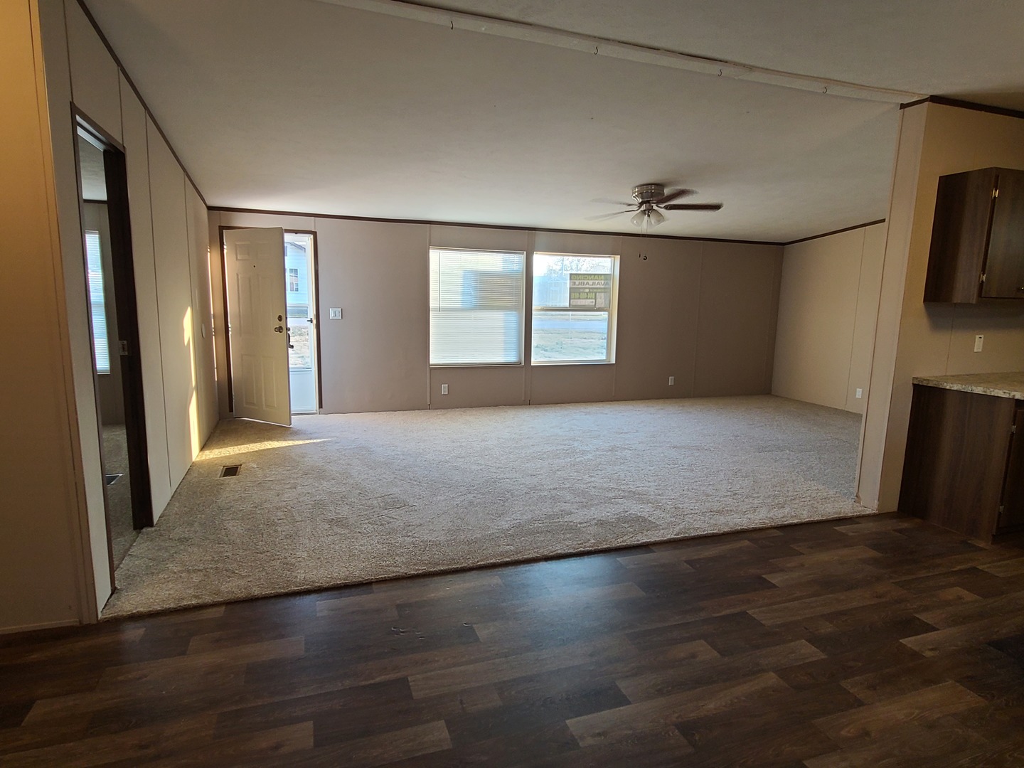 303 Seba Street Hurst, IL 62949 - Photo 2 of 13 an empty room with wooden floor and windows
