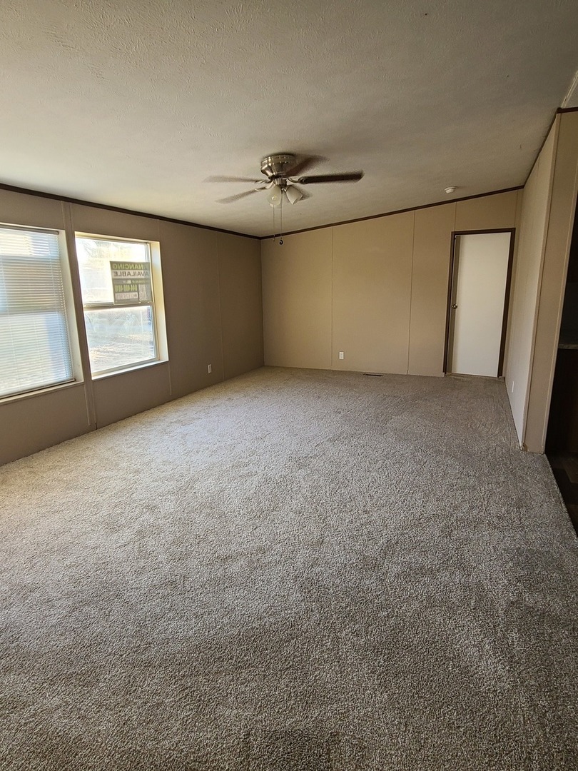 303 Seba Street Hurst, IL 62949 - Photo 3 of 13 an empty room with windows