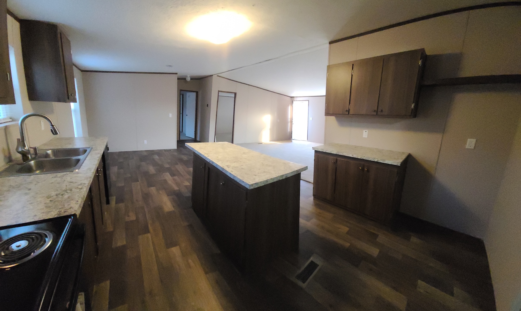 303 Seba Street Hurst, IL 62949 - Photo 4 of 13 a kitchen with kitchen island sink refrigerator and stove