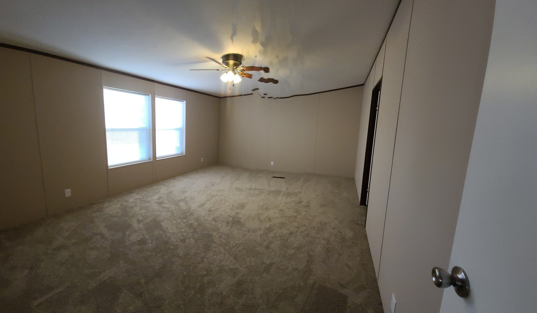 303 Seba Street Hurst, IL 62949 - Photo 9 of 13 an empty room with windows and chandelier fan