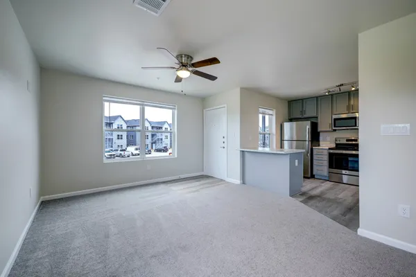 a view of a kitchen with a dishwasher cabinets and a large window