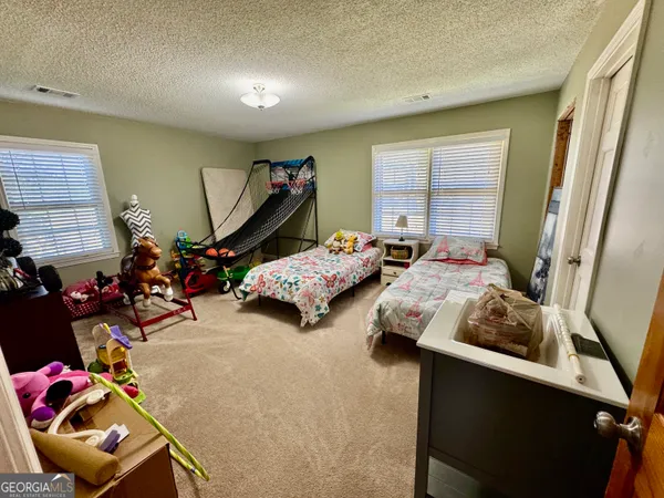 a bedroom with two beds and a window