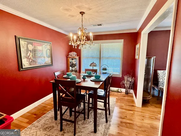 a view of a dining room with furniture and wooden floor